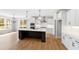 Spacious kitchen with white cabinets, a stainless hood, an island and hardwood floors at 55 Firefly Ln, Louisburg, NC 27549
