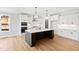Spacious kitchen with white cabinets, a stainless hood, an island and hardwood floors at 55 Firefly Ln, Louisburg, NC 27549