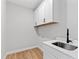 Laundry room with cabinets, countertop, and sink at 55 Firefly Ln, Louisburg, NC 27549