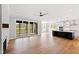 Open-concept living room featuring a fireplace, access to a sunroom, and view into kitchen at 55 Firefly Ln, Louisburg, NC 27549