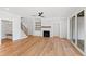 Open concept living room with hardwood floors, fireplace, built-ins and stairs at 55 Firefly Ln, Louisburg, NC 27549