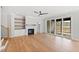 Open concept living room with hardwood floors, fireplace, built-ins and sliding glass doors at 55 Firefly Ln, Louisburg, NC 27549