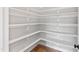 Large walk-in pantry with many white shelves for ample food storage at 55 Firefly Ln, Louisburg, NC 27549