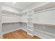 Walk-in closet offering ample shelving and wood floors at 55 Firefly Ln, Louisburg, NC 27549
