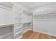 Walk-in closet offering ample shelving and wood floors at 55 Firefly Ln, Louisburg, NC 27549