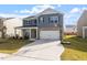 Two-story home with brick accents, covered porch, and driveway with basketball hoop at 628 Dorado Rd, Wendell, NC 27591