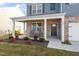 Inviting front porch with brick accents and chairs, perfect for relaxing outdoors at 628 Dorado Rd, Wendell, NC 27591