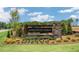 Landscaped entrance sign for Anderson Farm neighborhood featuring stone and wood details at 628 Dorado Rd, Wendell, NC 27591