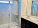 A modern bathroom featuring a glass-enclosed shower, double vanity, and ample counter space at 140 Token House Rd, Durham, NC 27703