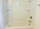 Clean, white bathtub and shower combination with built-in shelving at 140 Token House Rd, Durham, NC 27703
