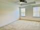 Bright bedroom with a ceiling fan and two windows offering plenty of natural light at 140 Token House Rd, Durham, NC 27703