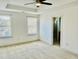 Spacious bedroom features a ceiling fan, two windows, and an ensuite bathroom at 140 Token House Rd, Durham, NC 27703