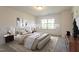 This staged bedroom is bathed in natural light from the nearby window at 140 Token House Rd, Durham, NC 27703