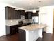 Kitchen features stainless steel appliances, granite countertops, dark cabinets, and an island with a sink at 140 Token House Rd, Durham, NC 27703