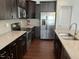Featuring stainless steel appliances, granite countertops, and dark cabinets, this kitchen is designed for modern living at 140 Token House Rd, Durham, NC 27703