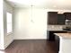 This kitchen shows dark cabinets, granite countertops, stainless appliances, and a dining area, exuding elegance at 140 Token House Rd, Durham, NC 27703