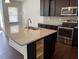 Modern kitchen with granite countertops, dark cabinetry, and stainless steel appliances provides a contemporary living space at 140 Token House Rd, Durham, NC 27703