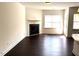 Spacious living room with a fireplace and hardwood floors, providing a clean and bright living space at 140 Token House Rd, Durham, NC 27703