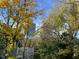 Landscaped backyard with mature trees and view of nearby buildings at 215 E Cabarrus St, Raleigh, NC 27601