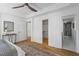 Bright bedroom features hardwood floors, ceiling fan, walk-in closet and ensuite bathroom access at 215 E Cabarrus St, Raleigh, NC 27601