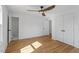 Bright bedroom featuring wood floors, a modern ceiling fan and plenty of closet space at 215 E Cabarrus St, Raleigh, NC 27601