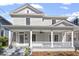 Inviting gray two-story home with a charming front porch and classic white columns at 215 E Cabarrus St, Raleigh, NC 27601