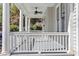 Classic covered front porch with white columns and ceiling fan at 215 E Cabarrus St, Raleigh, NC 27601