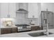 Modern kitchen featuring stainless steel appliances, white cabinetry, and stylish backsplash at 215 E Cabarrus St, Raleigh, NC 27601