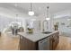 Open concept kitchen with island, view of dining and living areas, hardwood floors at 215 E Cabarrus St, Raleigh, NC 27601