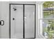 Modern black framed shower features tile surround, and looks out onto a green yard at 215 E Cabarrus St, Raleigh, NC 27601