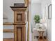 Close-up of staircase with decorative wooden newel post, adjacent to a cozy living space at 215 E Cabarrus St, Raleigh, NC 27601
