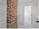 Walk-in closet features exposed brick accent wall and custom shelving at 215 E Cabarrus St, Raleigh, NC 27601