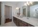 Bright bathroom with double sink vanity, large mirrors and view to walk in closet at 239 Harvester Rd, Angier, NC 27501