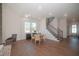 Open-concept dining room adjacent to stairs, with lots of natural light and hardwood floors at 239 Harvester Rd, Angier, NC 27501