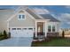 Charming single-Gathering home featuring a two-car garage, inviting entryway, and well-maintained landscaping at 239 Harvester Rd, Angier, NC 27501