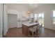 Bright modern kitchen with center island, lots of cabinets, stainless appliances, and easy access to the deck at 239 Harvester Rd, Angier, NC 27501