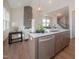 Beautiful kitchen island featuring a sink, stainless steel dishwasher, and view into the living area at 239 Harvester Rd, Angier, NC 27501