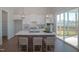 Bright kitchen with a spacious island, modern appliances, and easy access to the outdoor deck at 239 Harvester Rd, Angier, NC 27501