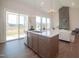 Modern kitchen island, sink, stainless steel dishwasher, and view to the living area and deck at 239 Harvester Rd, Angier, NC 27501