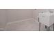 Laundry room featuring new floor, utility sink and neutral paint at 239 Harvester Rd, Angier, NC 27501
