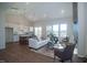 Open-concept living room with a fireplace, island kitchen, and lots of natural light at 239 Harvester Rd, Angier, NC 27501
