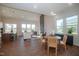 Bright living room with hardwood floors, multiple windows, and a modern fireplace feature wall at 239 Harvester Rd, Angier, NC 27501