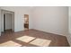 Spacious bedroom with hardwood floors and doorway to bathroom at 239 Harvester Rd, Angier, NC 27501