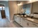 Modern bathroom featuring dual sinks, gray counters, and decorative patterned tile flooring at 274 Golden Leaf Farms Rd, Angier, NC 27501