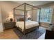 Serene bedroom with a canopy bed, stylish lamps, and a large window at 274 Golden Leaf Farms Rd, Angier, NC 27501