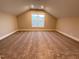 Spacious bonus room with neutral carpet and ample natural light from a large window at 274 Golden Leaf Farms Rd, Angier, NC 27501