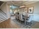 Elegant dining area with modern light fixture, stylish chairs, and hardwood floors at 274 Golden Leaf Farms Rd, Angier, NC 27501