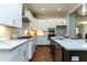 Gourmet kitchen featuring custom cabinetry, stainless appliances, and a center island with seating at 274 Golden Leaf Farms Rd, Angier, NC 27501
