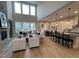 Open-concept living area with a cozy fireplace, large windows, and views of the kitchen at 274 Golden Leaf Farms Rd, Angier, NC 27501