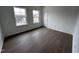 Well-lit bedroom with hardwood floors and two windows at 3317 Oakfields Rd # 5, New Hill, NC 27562